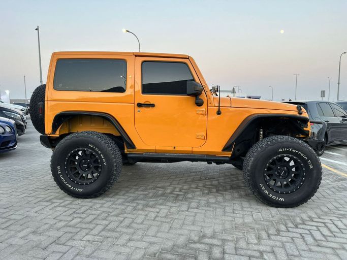 Used Jeep Wrangler III (JK), 3.6 l, 2013 in Abu Dhabi by Al Qeyada Motors, Orange color. American Specs | AUTO.AE