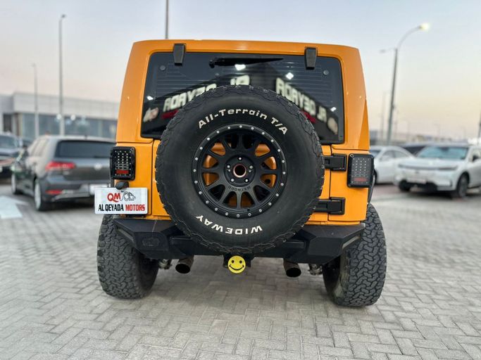 Used Jeep Wrangler III (JK), 3.6 l, 2013 in Abu Dhabi by Al Qeyada Motors, Orange color. American Specs | AUTO.AE