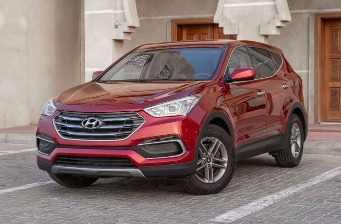Подержанный Hyundai Santa Fe III Рестайлинг, 2.0 л, 2017 в Аджмане от AMG Cars Красный цвет. Американская | AUTO.AE