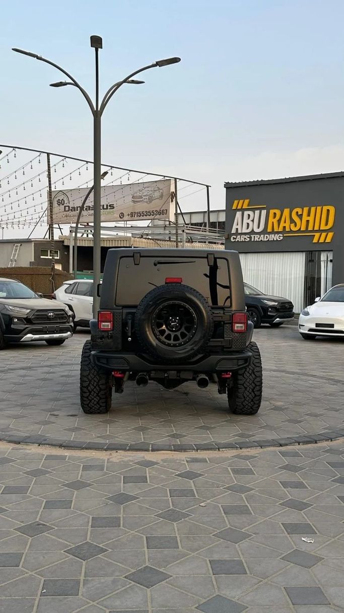 Подержанный Jeep Wrangler III (JK), 3.6 л, 2016 в Аджмане от Abu Rashid Cars  Черный цвет. Американская | AUTO.AE