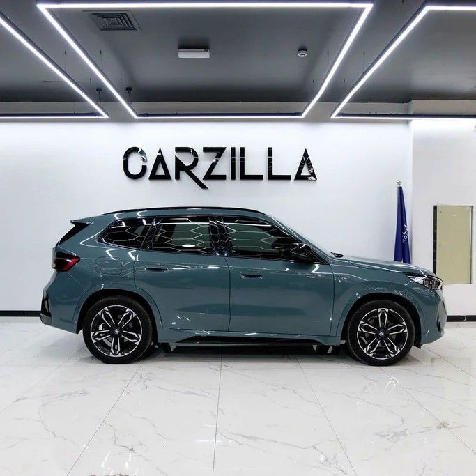 Used BMW X1 20i sDrive III (U11/U12), 1.5 l, 2024 in Dubai by Carzilla Motors, Teal color. GCC Specs | AUTO.AE