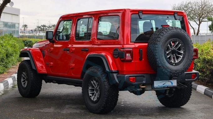 New Jeep Wrangler IV (JL) Facelift, 6.4 l, 2024 in Dubai by Auto Max Group, Red color. GCC Specs | AUTO.AE
