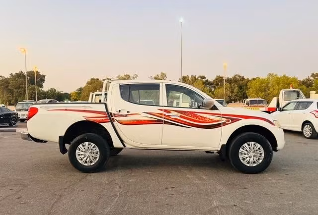 Used Mitsubishi L200 IV, 2.5 l, 2009 in Dubai by Alhamd Motors, White color. GCC Specs | AUTO.AE