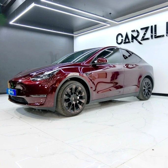Used Tesla Model Y Long Range I, 2023 in Dubai by Carzilla Motors, Burgundy color. GCC Specs | AUTO.AE