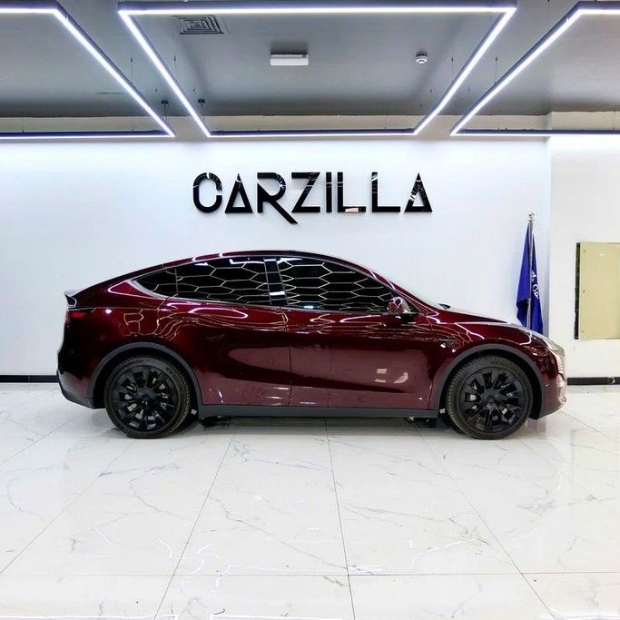 Used Tesla Model Y Long Range I, 2023 in Dubai by Carzilla Motors, Burgundy color. GCC Specs | AUTO.AE