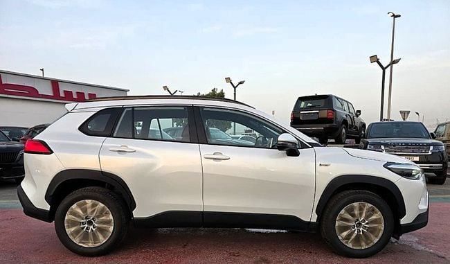 New Toyota Corolla Cross I, 1.8 l, 2025 in Dubai by Soltan Auto, White color. GCC Specs | AUTO.AE