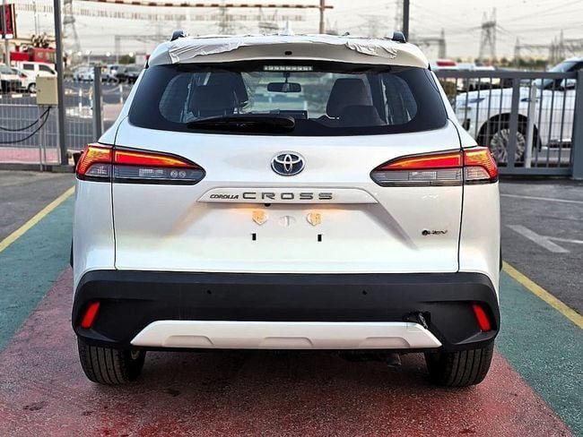 New Toyota Corolla Cross I, 1.8 l, 2025 in Dubai by Soltan Auto, White color. GCC Specs | AUTO.AE