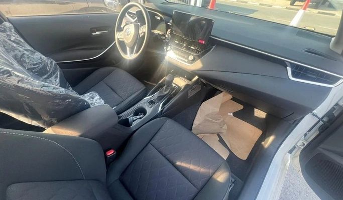 Новый Toyota Corolla Sporty XII (E210) Рестайлинг, 1.8 л, 2024 в Дубае от World Center Motors FZE Белый цвет. Китайская | AUTO.AE