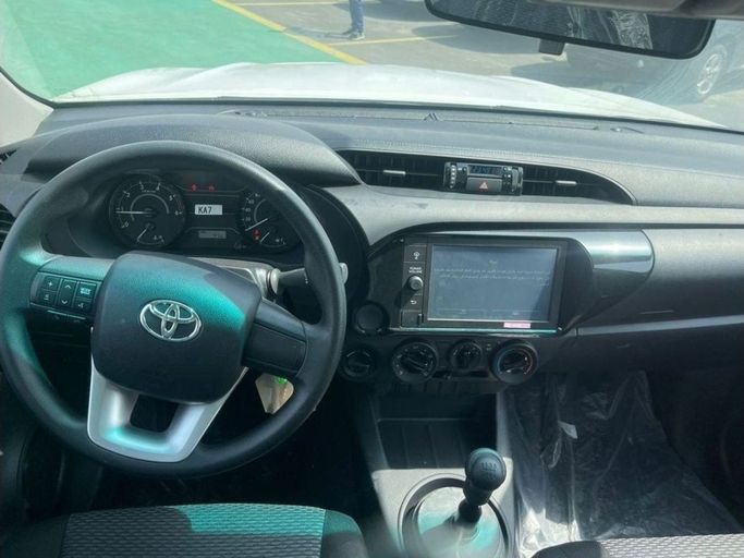 New Toyota Hilux VIII Facelift, 2.4 l, 2023 in Dubai by Mohamed Hakim Motors, White color. GCC Specs | AUTO.AE