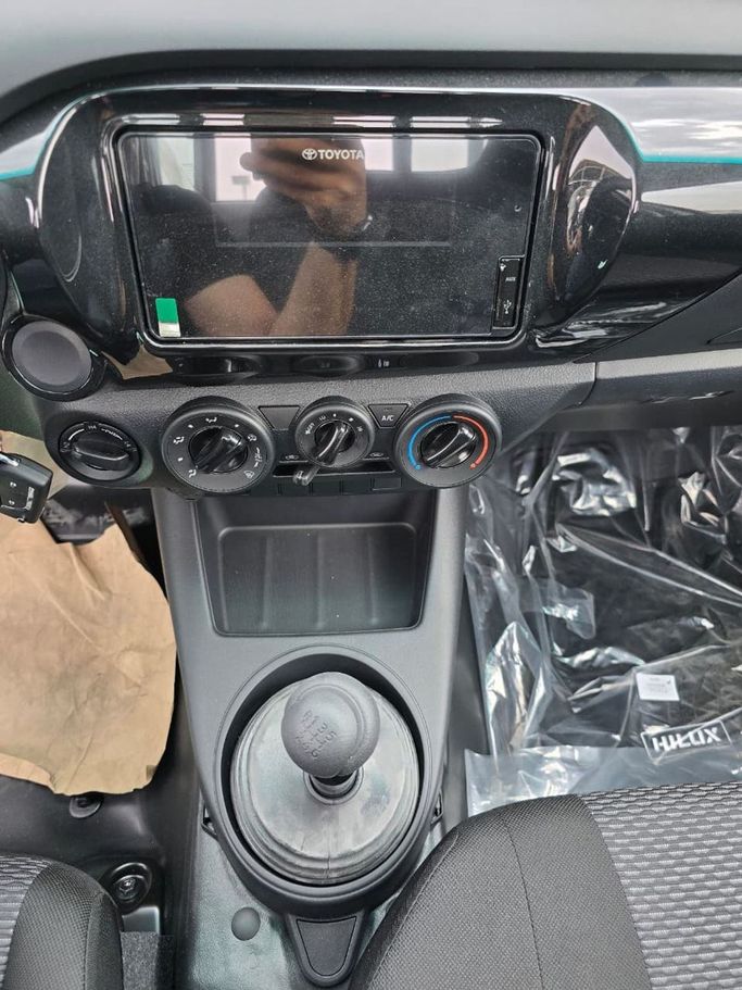 New Toyota Hilux Extra Cab VIII Facelift, 2.4 l, 2025 in Dubai by Mohamed Hakim Motors, White color. GCC Specs | AUTO.AE