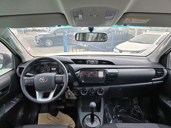 New Toyota Hilux Extra Cab VIII Facelift, 2.4 l, 2025 in Dubai by Mohamed Hakim Motors, White color. GCC Specs | AUTO.AE
