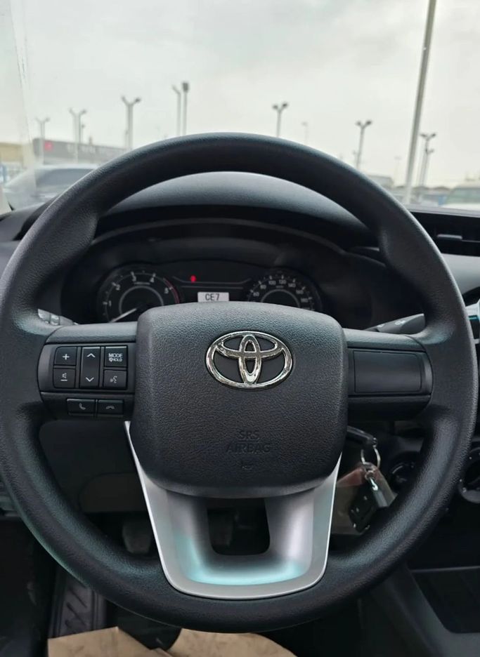 New Toyota Hilux Extra Cab VIII Facelift, 2.4 l, 2025 in Dubai by Mohamed Hakim Motors, White color. GCC Specs | AUTO.AE