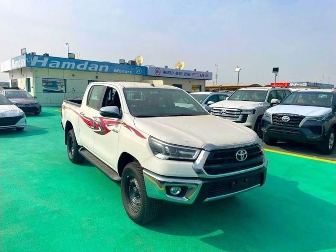 New Toyota Hilux VIII Facelift, 2.8 l, 2023 in Dubai by Mohamed Hakim Motors, White color. GCC Specs | AUTO.AE