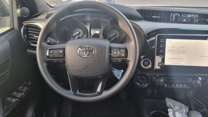 New Toyota Hilux VIII Facelift, 2.8 l, 2023 in Dubai by Mohamed Hakim Motors, White color. GCC Specs | AUTO.AE