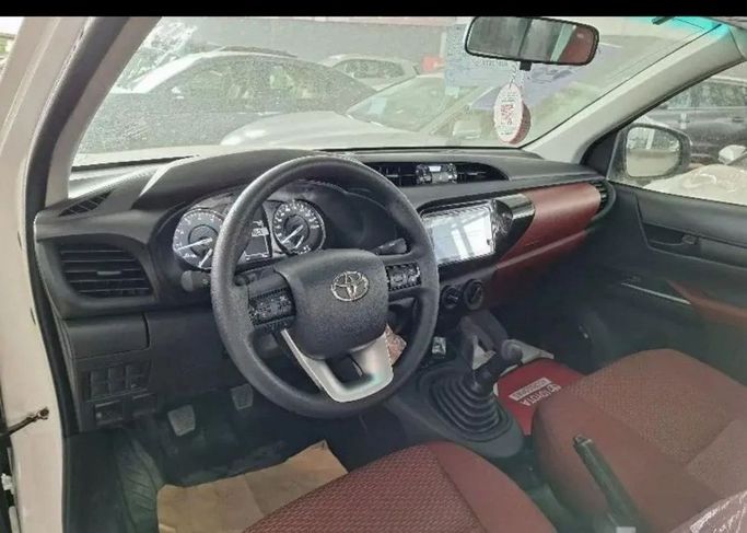 New Toyota Hilux Extra Cab VIII Facelift, 2.4 l, 2024 in Dubai by Mohamed Hakim Motors, White color. GCC Specs | AUTO.AE