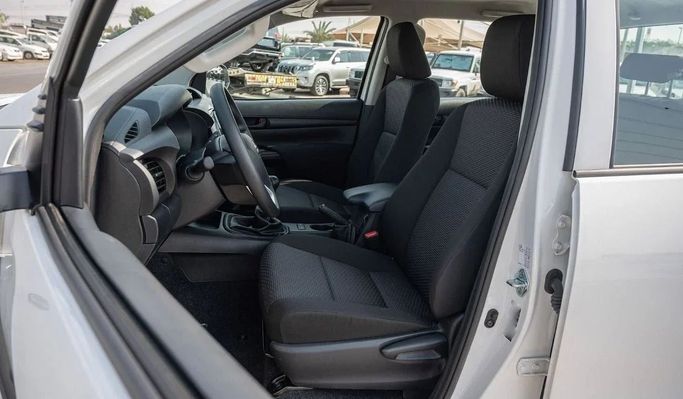New Toyota Hilux Extra Cab VIII Facelift, 2.4 l, 2023 in Dubai by Mohamed Hakim Motors, White color. GCC Specs | AUTO.AE