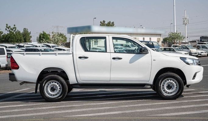 New Toyota Hilux Extra Cab VIII Facelift, 2.4 l, 2023 in Dubai by Mohamed Hakim Motors, White color. GCC Specs | AUTO.AE