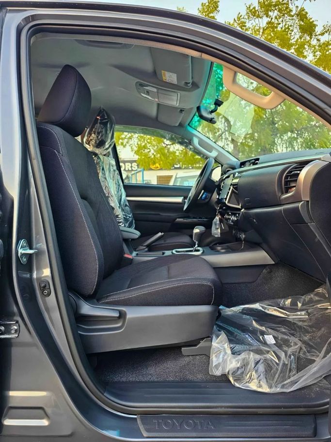 New Toyota Hilux VIII Facelift 2, 2.4 l, 2025 in Dubai by SK Motors, Grey color. GCC Specs | AUTO.AE