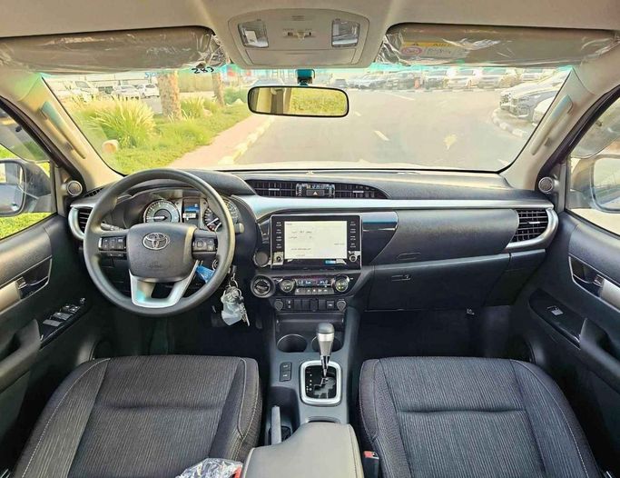 New Toyota Hilux VIII Facelift 2, 2.4 l, 2025 in Dubai by SK Motors, Grey color. GCC Specs | AUTO.AE