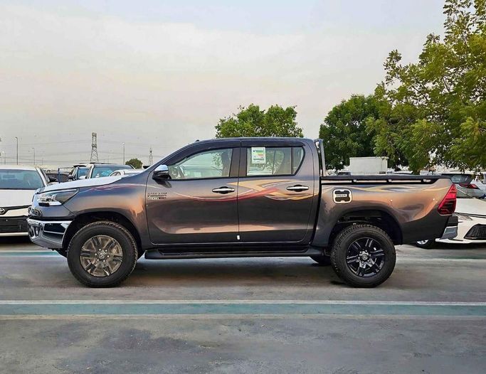 New Toyota Hilux VIII Facelift 2, 2.4 l, 2025 in Dubai by SK Motors, Grey color. GCC Specs | AUTO.AE