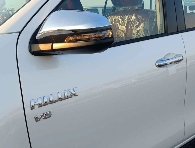 New Toyota Hilux VIII Facelift, 4.0 l, 2024 in Dubai by SK Motors, White color. GCC Specs | AUTO.AE