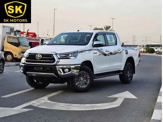 New Toyota Hilux VIII Facelift 2, 2.7 l, 2024 in Dubai by SK Motors, White color. GCC Specs | AUTO.AE