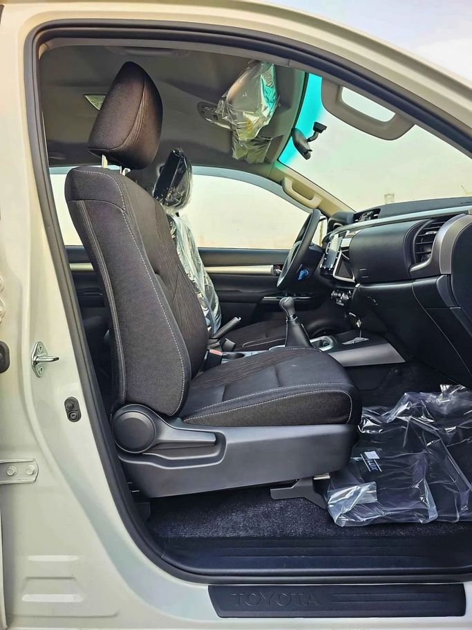 New Toyota Hilux VIII Facelift 2, 2.7 l, 2024 in Dubai by SK Motors, White color. GCC Specs | AUTO.AE