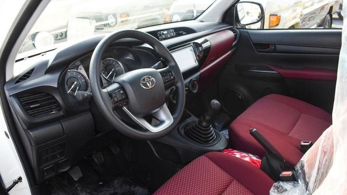 New Toyota Hilux Extra Cab VIII Facelift, 2.4 l, 2024 in Dubai by Najem Motors, White color. GCC Specs | AUTO.AE