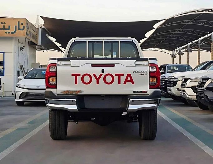 New Toyota Hilux VIII Facelift, 2.4 l, 2025 in Dubai by SK Motors, White color. GCC Specs | AUTO.AE