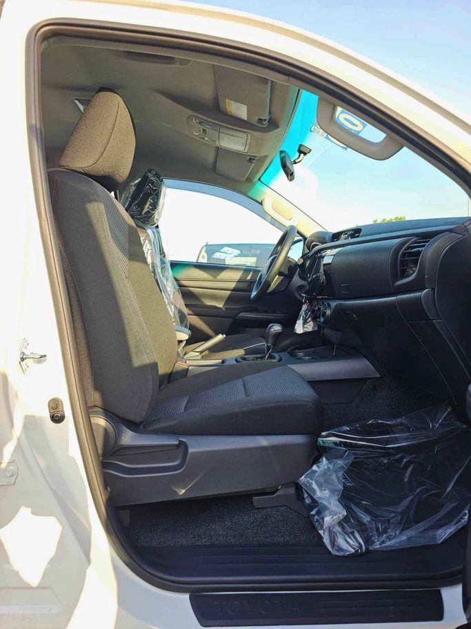 New Toyota Hilux VIII Facelift, 2.4 l, 2025 in Dubai by SK Motors, White color. GCC Specs | AUTO.AE