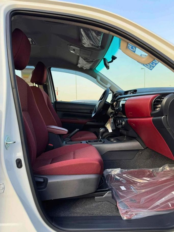 New Toyota Hilux VIII Facelift, 2.4 l, 2025 in Dubai by SK Motors, White color. GCC Specs | AUTO.AE
