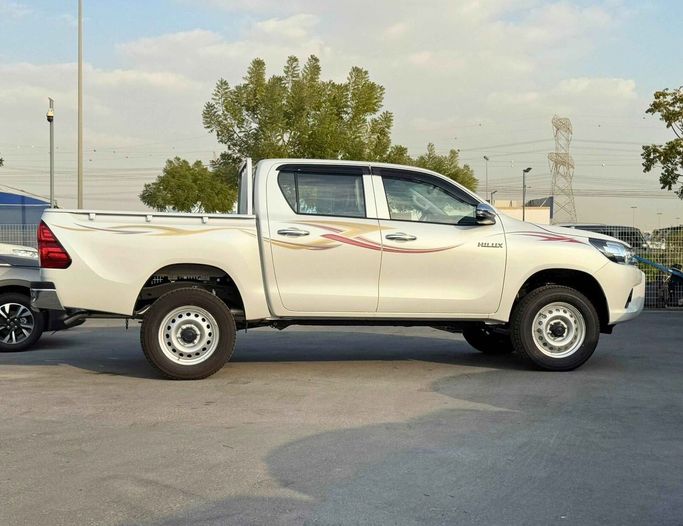 New Toyota Hilux VIII Facelift, 2.4 l, 2025 in Dubai by SK Motors, White color. GCC Specs | AUTO.AE