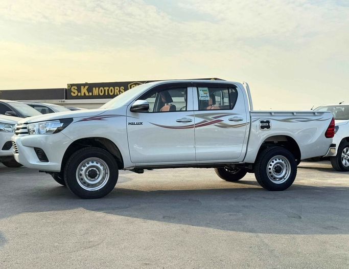 New Toyota Hilux VIII Facelift, 2.4 l, 2025 in Dubai by SK Motors, White color. GCC Specs | AUTO.AE