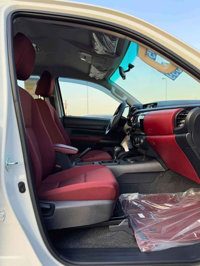New Toyota Hilux VIII Facelift, 2.4 l, 2025 in Dubai by SK Motors, White color. GCC Specs | AUTO.AE