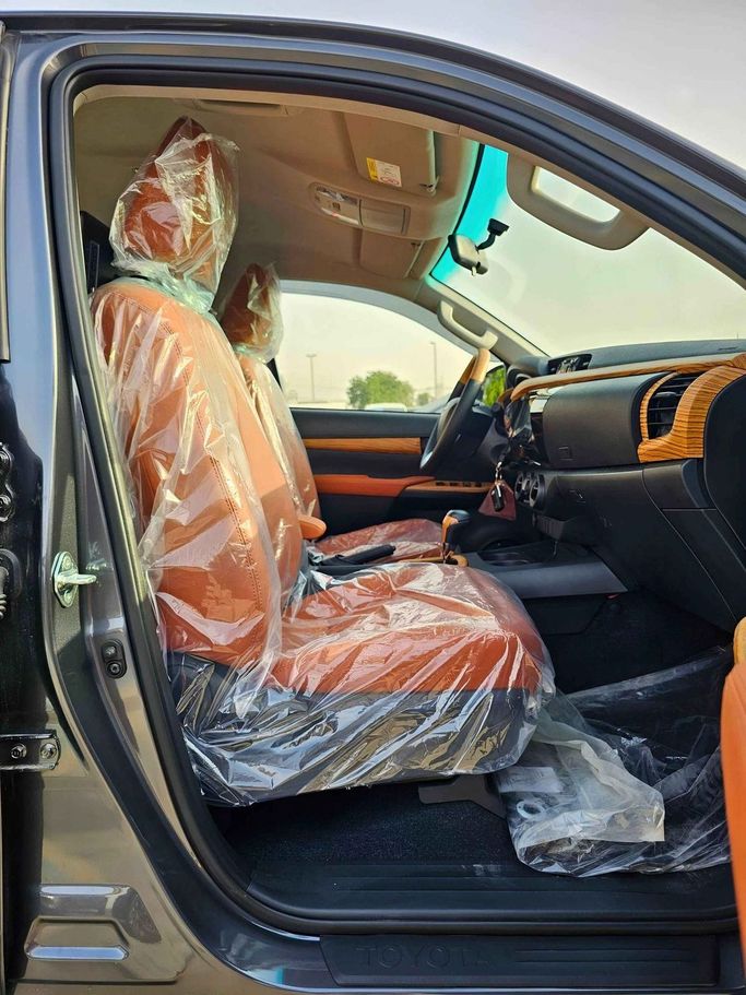 New Toyota Hilux VIII Facelift, 2.4 l, 2025 in Dubai by SK Motors, Grey color. GCC Specs | AUTO.AE