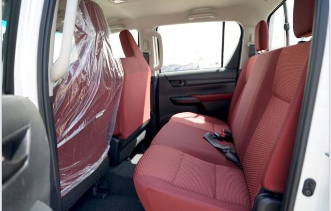 New Toyota Hilux Extra Cab VIII Facelift, 2.4 l, 2025 in Dubai by Pegasus Automobile, White color. GCC Specs | AUTO.AE