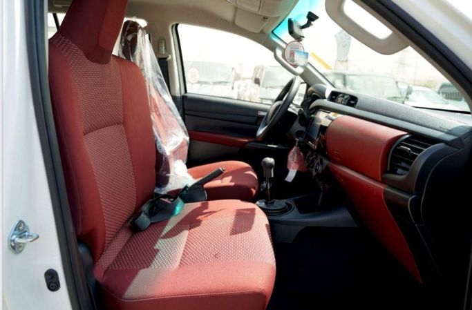 New Toyota Hilux Extra Cab VIII Facelift, 2.4 l, 2025 in Dubai by Pegasus Automobile, White color. GCC Specs | AUTO.AE