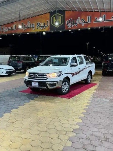 Новый Toyota Hilux VIII Рестайлинг 2, 2.4 л, 2026 в Саудовская Аравия, Медина от Hamed Al Jabri Cars مؤسسة حامد الجابري للسيارت Белый цвет.  | AUTO.AE | Объявление #268615