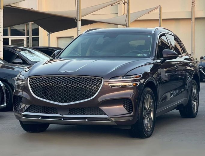 Used Genesis GV70 I, 2.5 l, 2023 in Sharjah by Al Nukhba Al Malakyah Used Cars, Burgundy color. American Specs | AUTO.AE