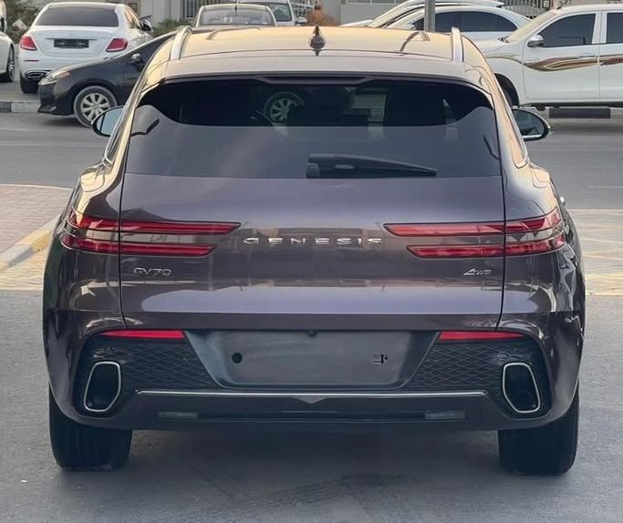 Used Genesis GV70 I, 2.5 l, 2023 in Sharjah by Al Nukhba Al Malakyah Used Cars, Burgundy color. American Specs | AUTO.AE