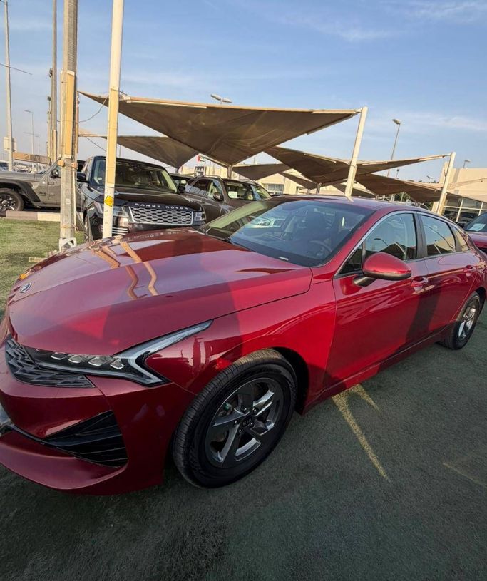 Used Kia K5 III, 1.6 l, 2021 in Sharjah by Al Masah Al Malakia, Red color. American Specs | AUTO.AE