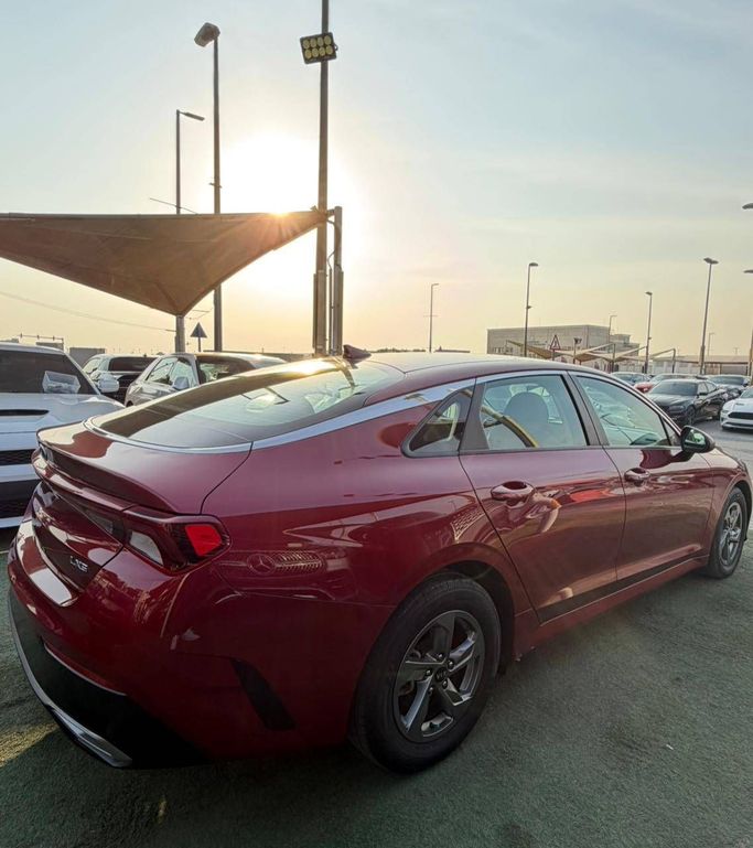 Used Kia K5 III, 1.6 l, 2021 in Sharjah by Al Masah Al Malakia, Red color. American Specs | AUTO.AE