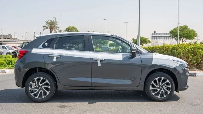 New Suzuki Baleno III, 1.5 l, 2023 in Sharjah by Nour Alnukhba Motors, Grey color. GCC Specs | AUTO.AE