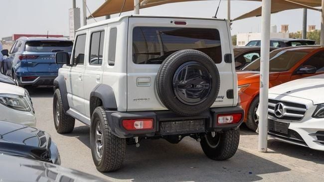 Used Suzuki Jimny IV, 1.5 l, 2024 in Sharjah by Alnujoom Al Malakiah Used Cars, White color. GCC Specs | AUTO.AE