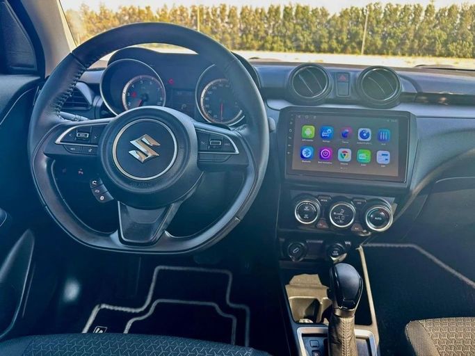 Used Suzuki Swift V, 1.2 l, 2024 in Sharjah by Noor Al Seyoh Used Cars, Red color. GCC Specs | AUTO.AE