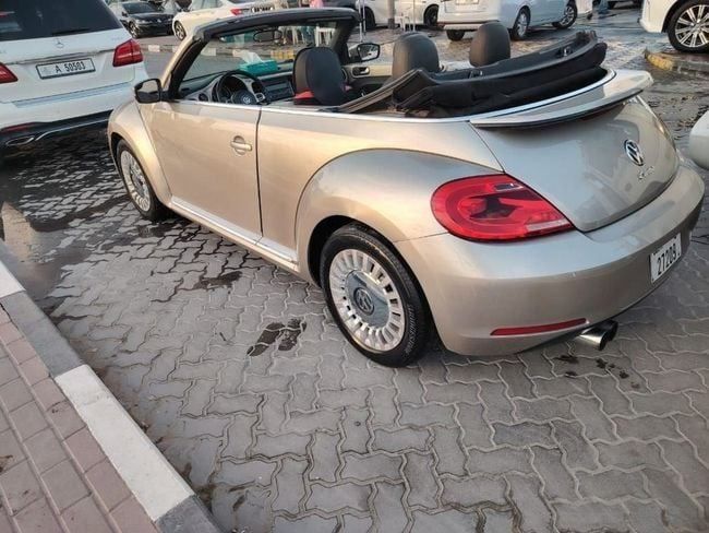 Used Volkswagen Beetle II (A5), 1.8 l, 2014 in Sharjah by Alnujoom Al Malakiah Used Cars, Golden color. American Specs | AUTO.AE