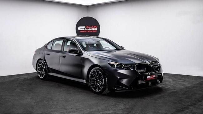New BMW M5 VII (G90), 4.4 l, 2025 in Dubai by Al Ain Class Motors, Black color. GCC Specs | AUTO.AE