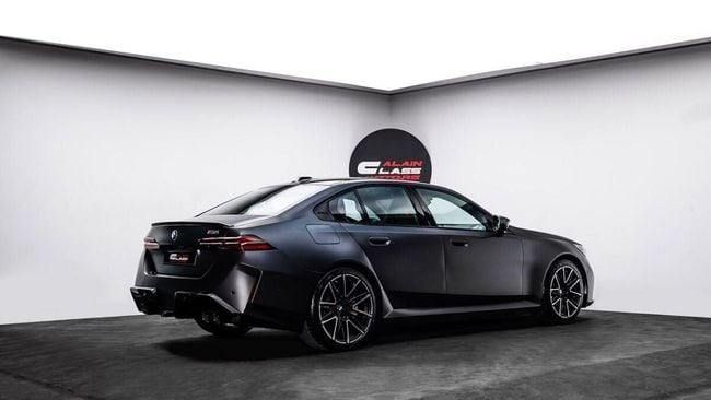 New BMW M5 VII (G90), 4.4 l, 2025 in Dubai by Al Ain Class Motors, Black color. GCC Specs | AUTO.AE