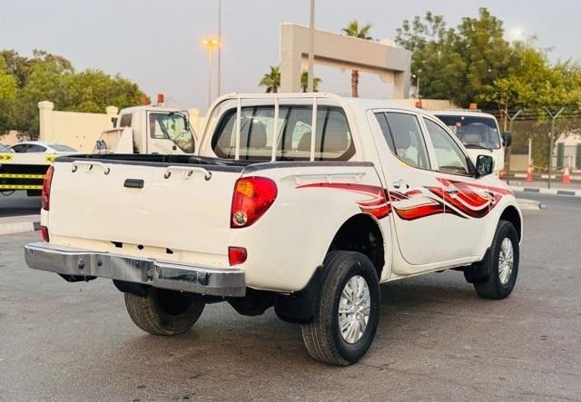 Подержанный Mitsubishi L200 IV, 2.5 л, 2009 в Дубае от Alhamd Motors Белый цвет. GCC | AUTO.AE
