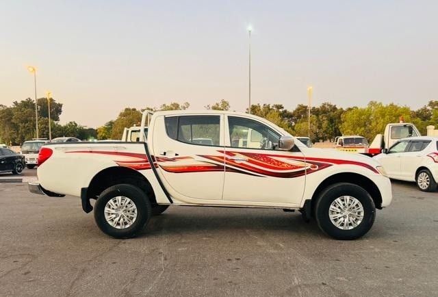 Подержанный Mitsubishi L200 IV, 2.5 л, 2009 в Дубае от Alhamd Motors Белый цвет. GCC | AUTO.AE